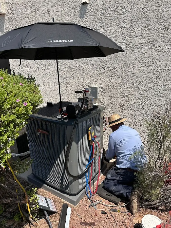 HVAC technician performing outdoor AC maintenance in Willoughby